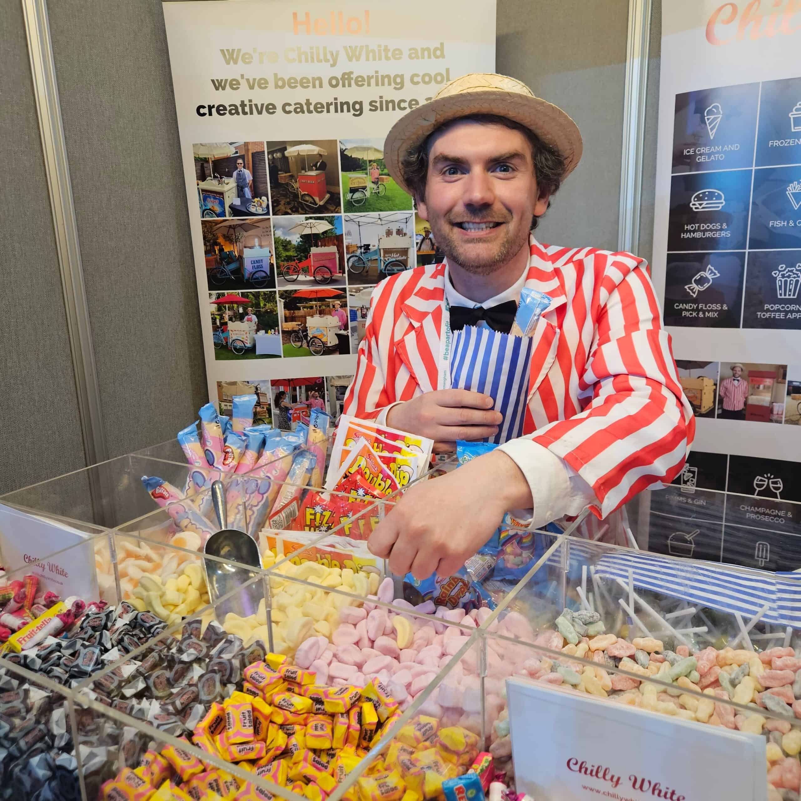 Traditional Pick and mix sweets tricycle hire with a uniformed in red and white striped blazer with bow-tie and boater hat