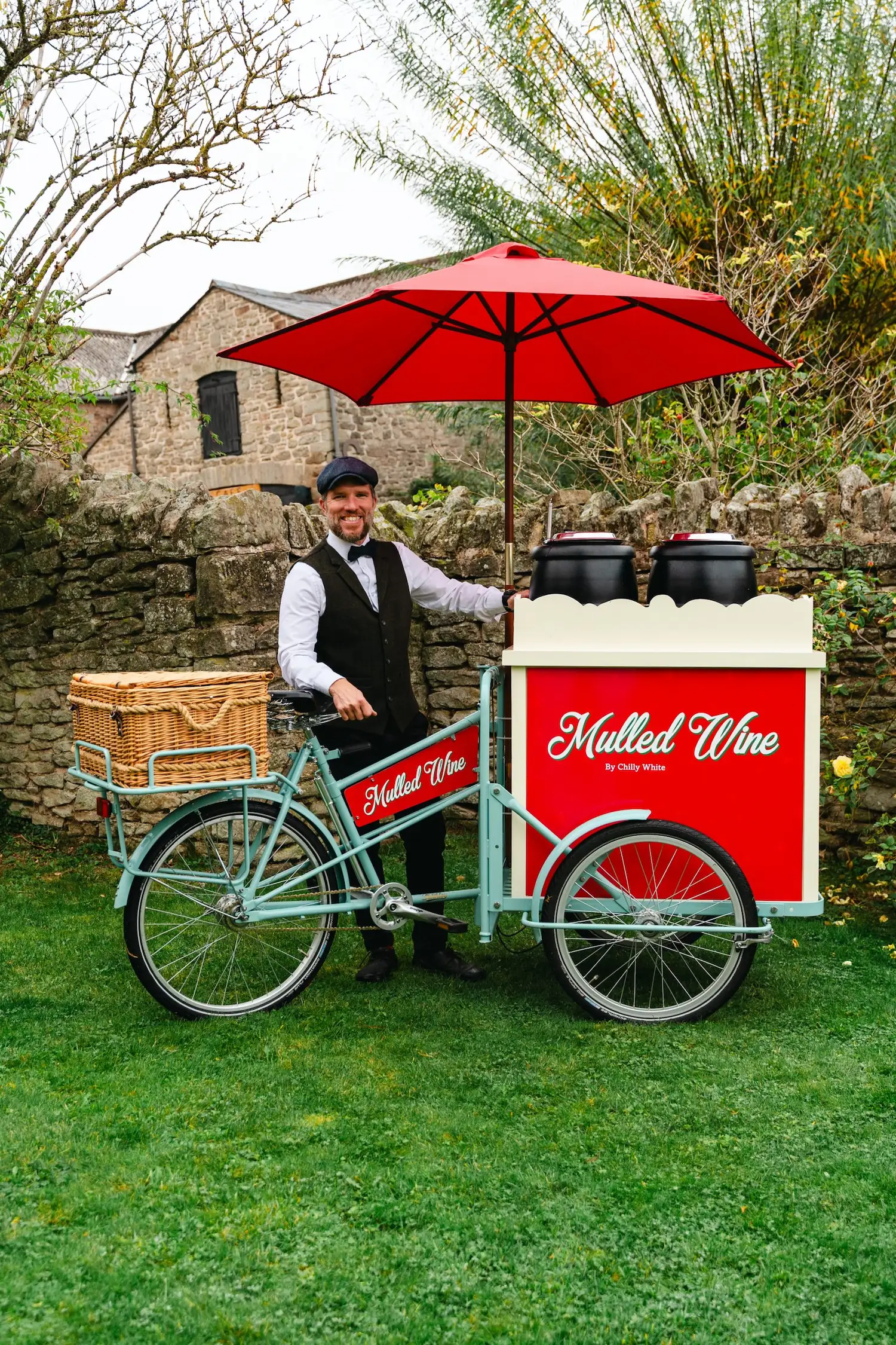 Chilly White Mulled Wine tricycle with smartly dressed uniformed server sett up in a English garden