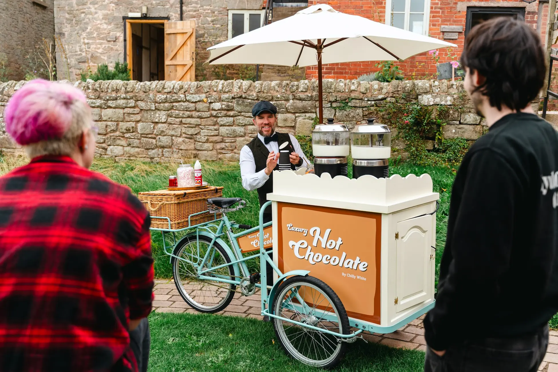 Chilly white luxury hot chocolate tricycle with a server dressed in traditional attire